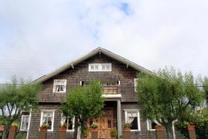 a house with trees in front of it at Hotel Boutique Casa Werner in Puerto Varas +159 photos