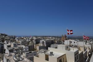 a view of a city with two canadian flags at Victoria by Petit Chic in Mellieħa