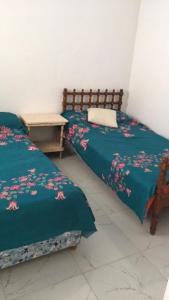 two beds sitting next to each other in a room at شاليه زمردة in Dawwār Shindī Fannūsh +15 photos