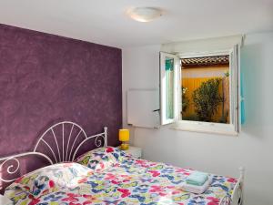 a bedroom with a bed and a window at Apartman Nik in Nova Vas