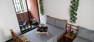 a room with a bed and a table and a window at Moradia Laureles Medellin in Medellín