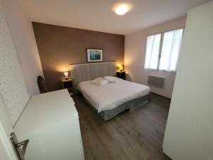 a small bedroom with a bed and a window at Les contines in Bagnoles de l'Orne