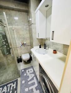 a bathroom with a sink and a washing machine at Bosphorus Seaview flat & Alexa smart home by SUMMITVISTA in Istanbul