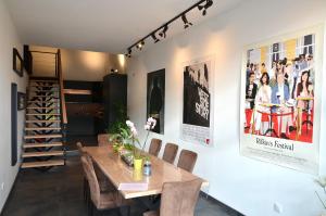 a dining room with a wooden table and chairs at Loft industriel dans une ancienne grange in Guenviller