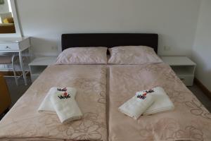 a bed with two white pillows on it at Apartmani Vlašić-Petrol in Travnik