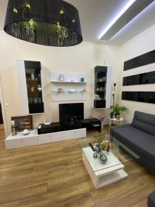 a living room with a couch and a table at Cozy apartment in downtown Sofia - Tsar Samuil Street in Sofia