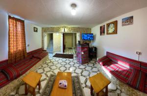 a living room with a couch and a tv at Orient Gate in Wadi Musa