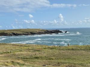 a view of the ocean from a hill with a beach at LOGEMENT en rdc Port Haliguen in Quiberon