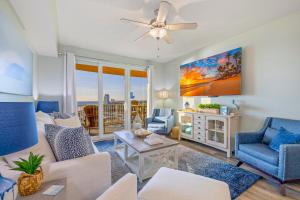 a living room with a couch and chairs and a ceiling fan at Beach N View Calypso 3 in Panama City Beach