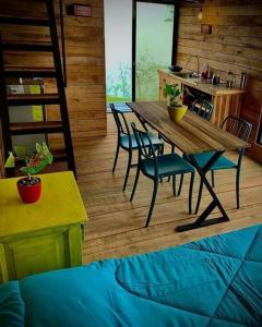 a wooden table and chairs in a room with a kitchen at Alto Luciérnaga 