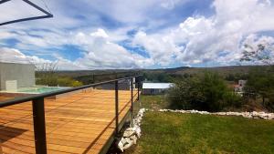 a balcony of a house with a swimming pool at La Ñata in Villa Giardino +4 photos