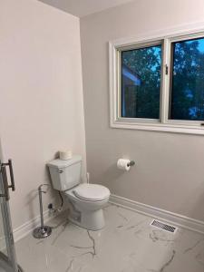 uma casa de banho branca com um WC e uma janela em Marmora Hideaway - Lake front em Marmora