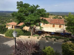 a house with a tree and a street light at Le Chardon 1 in Baudinard