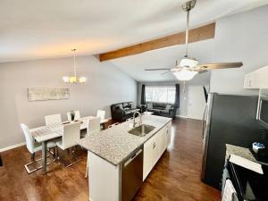 a kitchen and living room with a kitchen and a dining room at NEW! Remodeled Stow/Cuyahoga Falls Home! in Stow