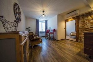 a living room with a fireplace and a living room with a table at Guesthouse Le Vauban in Neuf-Brisach