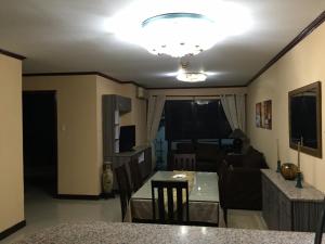 a kitchen and living room with a table and a couch at Rare 1BR condo, Makati Philippines in Manila