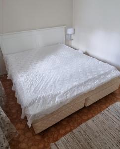 a bed in a bedroom with a white mattress at Mysig Lägenhet för resande. in Stocka