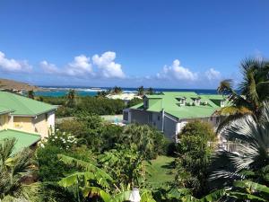 an aerial view of a resort with the ocean in the background at Maison PAPAGAYO in Oyster Pond