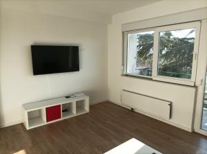 a living room with a flat screen tv on a wall at Apartman Pećine in Rijeka