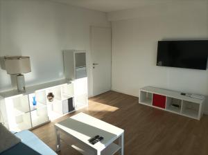 a living room with a couch and a tv at Apartman Pećine in Rijeka