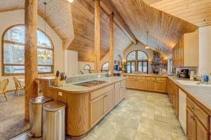 a large kitchen with wooden ceilings and a large center island at Donner Lake House in Truckee
