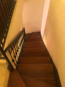 a staircase leading up to a building with wooden stairs at Propre appartement à loué pour les familles in Marrakesh