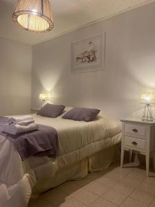 a bedroom with a bed and a night stand with two lamps at Hostería La Celestina in Tilcara +27 photos