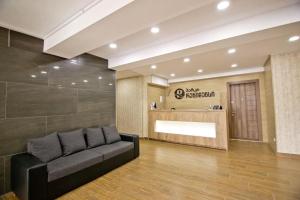 a lobby with a black couch in a room at Park residence in Bakuriani