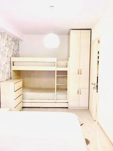 a white bedroom with a bed and white cabinets at Park residence in Bakuriani +27 photos