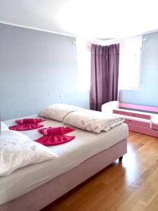 a bedroom with two beds with red pillows on them at Alpen Panorama view Luxury House with green Garden in Buchs