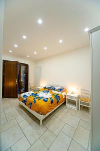 ein Schlafzimmer mit einem großen Bett mit einer orangefarbenen Decke in der Unterkunft Irpinia BikeHouse in Montella