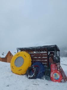 a truck is parked in the snow with tires at Domki pod Bukowym Lasem in Wańkowa +182 photos