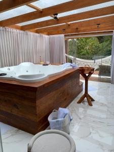 a large bath tub in a room with a table at POUSADA BELA VISTA in Pirenópolis