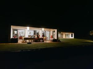 a group of people sitting on a patio at night at Casa do Cabeçudo in Faro