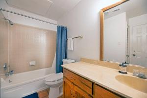 a bathroom with a sink and a toilet and a mirror at Charming mini-suite in West Campus! in Austin