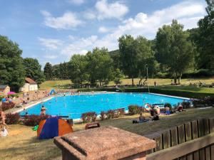a large swimming pool with people in a park at Cozy Apartment in Altenbrak