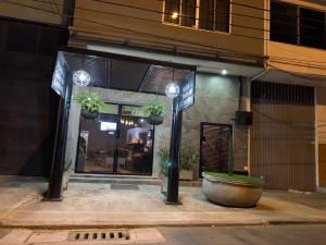 a store front with potted plants in front of it at Hotel Bisou in Cali