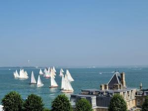 a group of sailboats in the water near a city at Franks, Cowes - Sleeps 4 - 2 Bed - 2 Bath - Central Location in Cowes