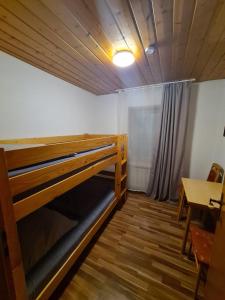a room with a bunk bed and a table at Ferienhaus Auszeit in Seebach