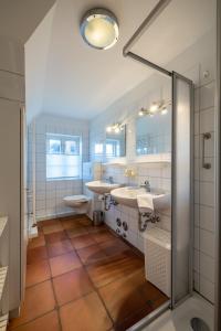 a bathroom with two sinks and two mirrors at Ferienwohnung Britta in Wyk auf Föhr