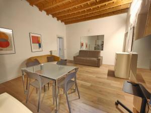 a living room with a glass table and chairs at Crocetta Charme Apartment in Milan