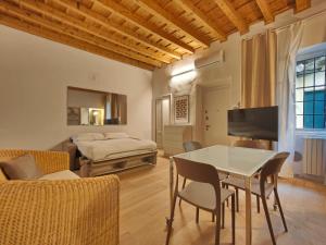 a living room with a table and chairs and a bed at Crocetta Charme Apartment in Milan