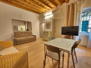 a living room with a table and a couch at Crocetta Charme Apartment in Milan +2 photos
