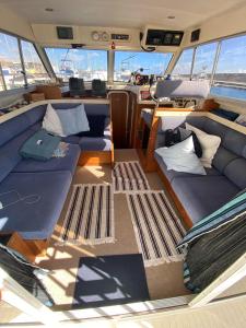 a large boat with couches and pillows on it at Barco Princess Cachucho Fly in Puerto Calero