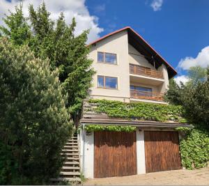 a house with a fence and a garage at Chata Anděl in Vrchlabí