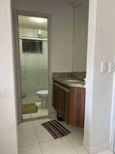 a bathroom with a shower and a sink and a toilet at Lagoa Quente Flat Service in Caldas Novas