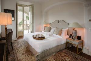 a bedroom with a large bed with a basket on it at Quinta da Bella Vista - Historic Home and Farm in Sintra