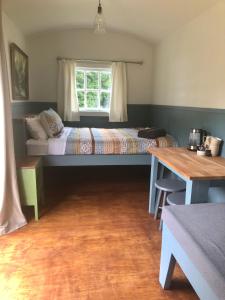 a bedroom with a bed and a window at Greytown Campground in Greytown