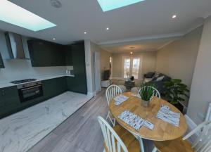 a kitchen and living room with a table and chairs at Homely & Peaceful Living Space in Morden