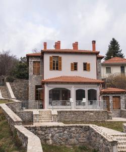 an external view of a house with stone steps at Anastasia's Suites Arcadia in Vitina